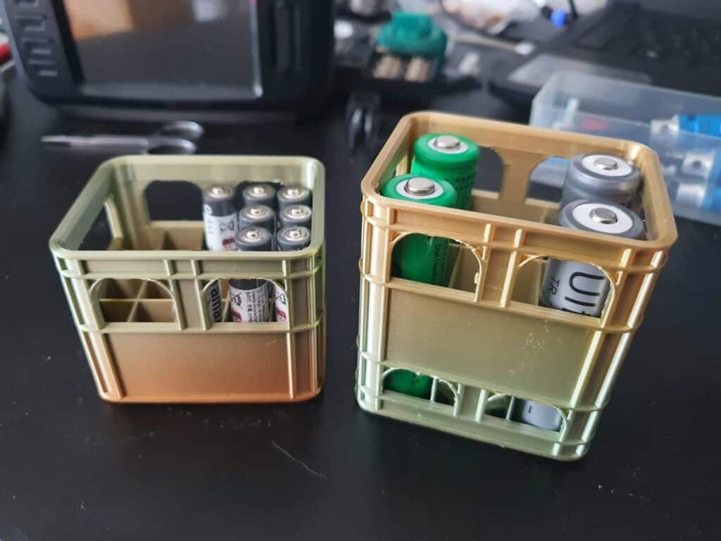 Assorted batteries in two small storage crates.