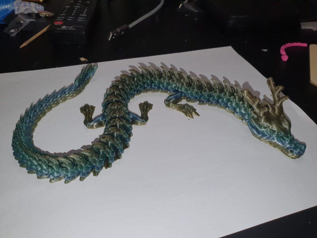 Intricate dragon sculpture on desk, detailed scales, fantasy decor.