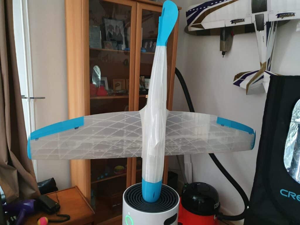 Model glider displayed indoors, with blue accents.