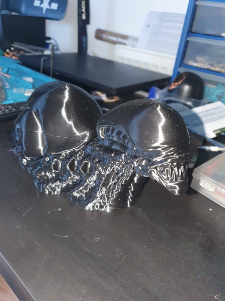 Black alien skull sculpture on desk