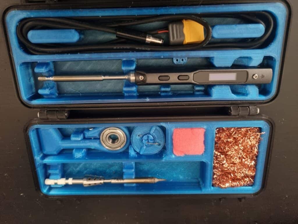 Soldering kit in blue case with tools and accessories.