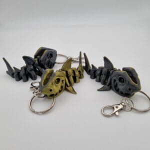 Fish-shaped keychains with articulated bodies on white background