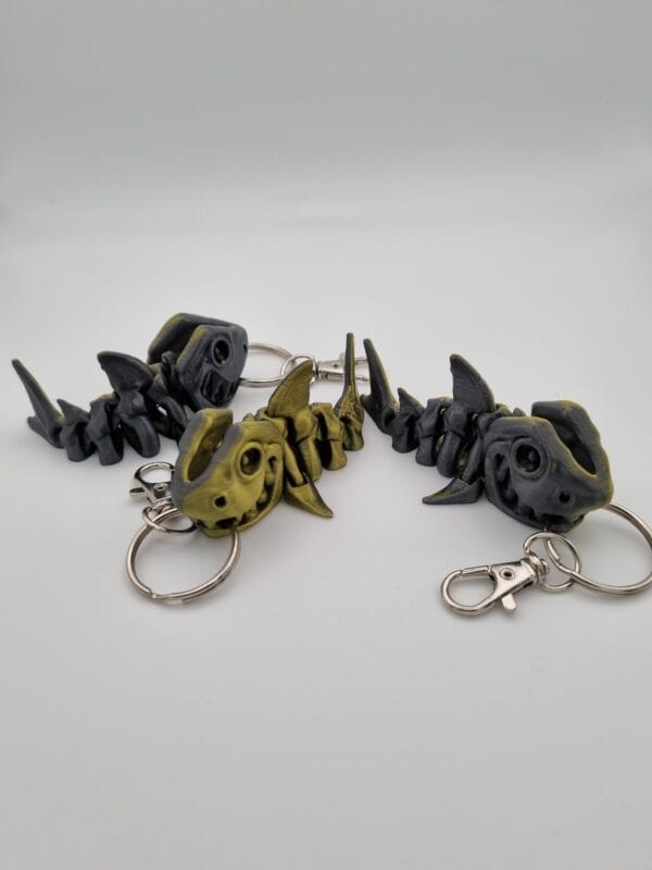 Fish-shaped keychains with articulated bodies on white background