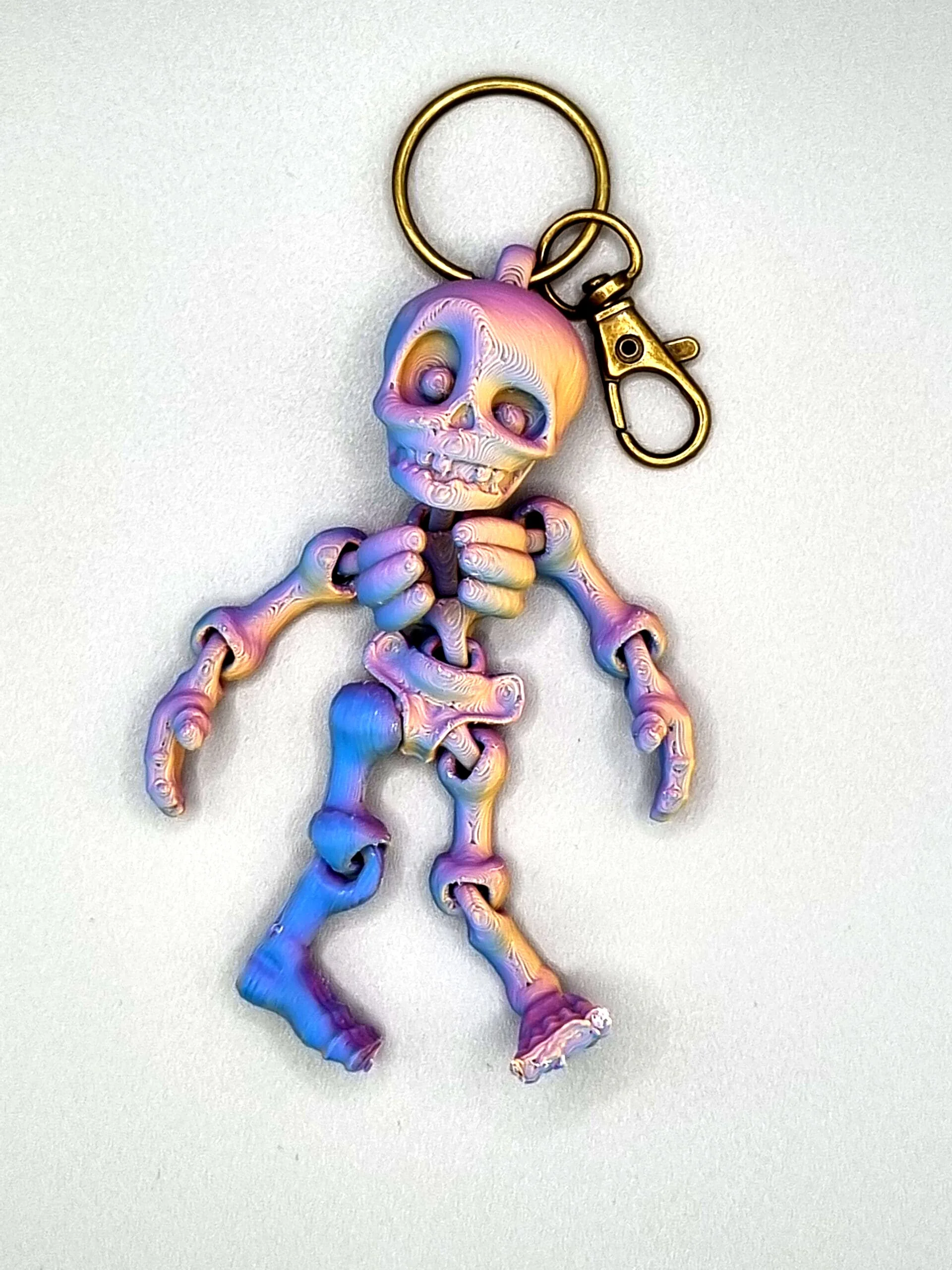 Iridescent skeleton keyring with gold clip