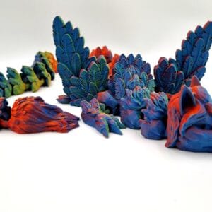 Colourful 3D-printed dragon figurines arranged on white background