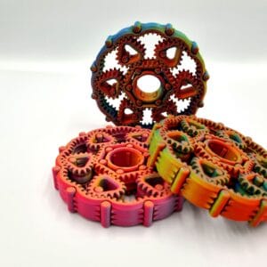 Colourful 3D-printed interlocking gear mechanism on white background