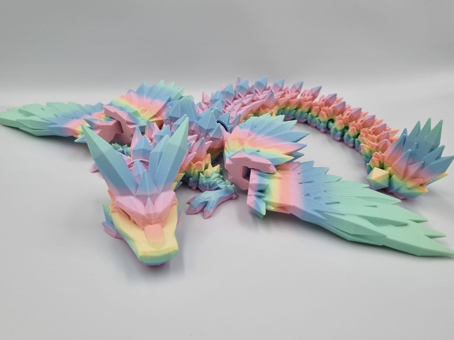 Pastel rainbow 3D-printed dragon with crystal-like spikes