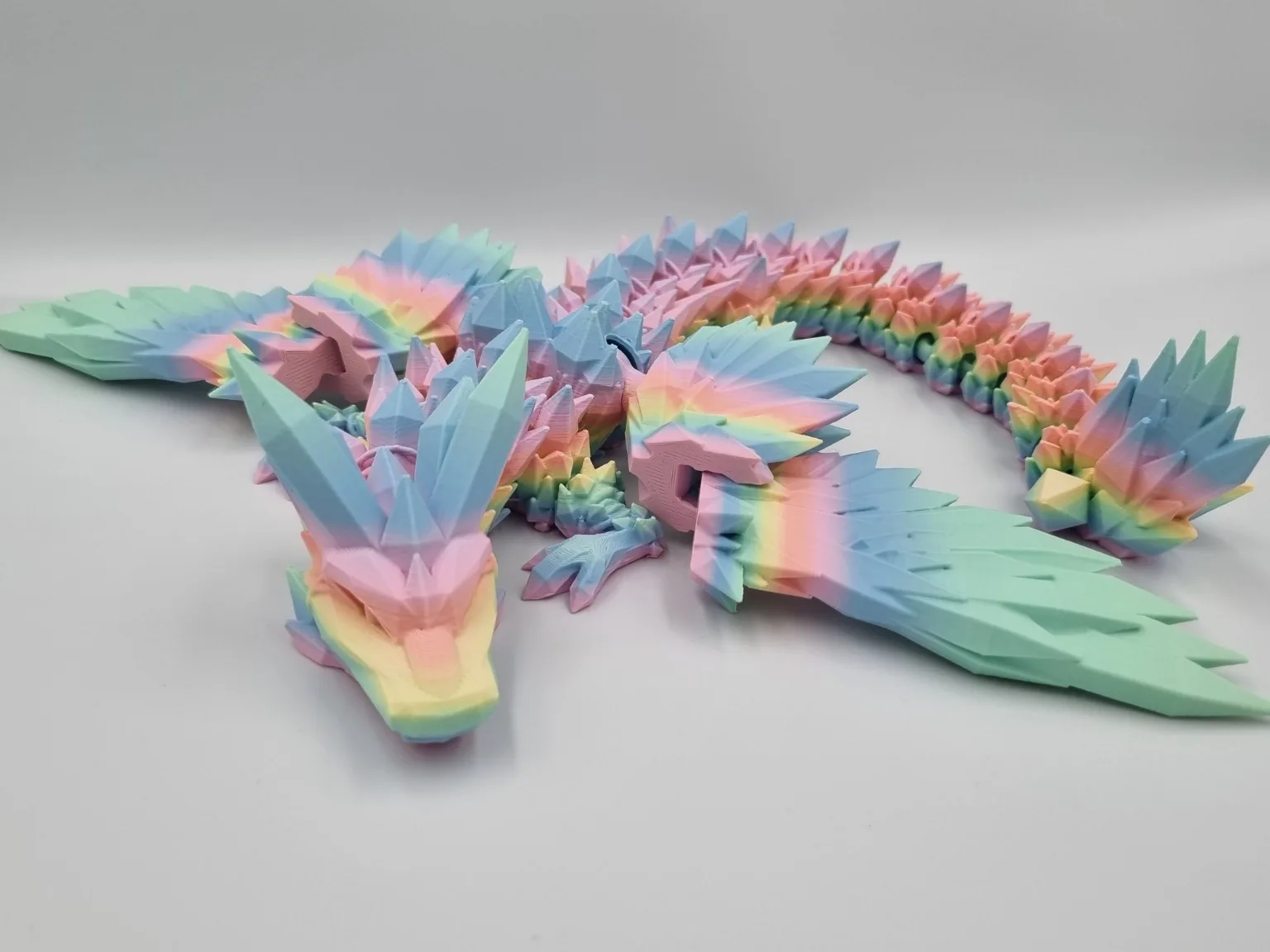 Pastel rainbow 3D-printed dragon with crystal-like spikes