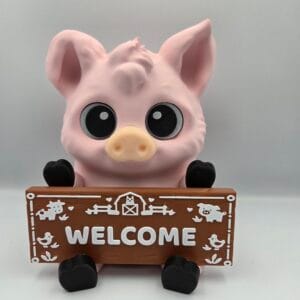 Pink pig figurine holding a welcome sign