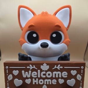 Cute fox figurine holding a Welcome Home sign